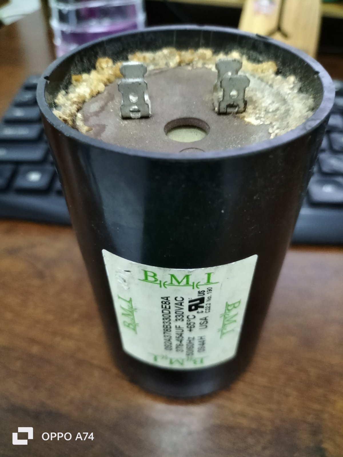 BMI starting capacitor 378-454UF black cylindrical electrical component with metal terminals