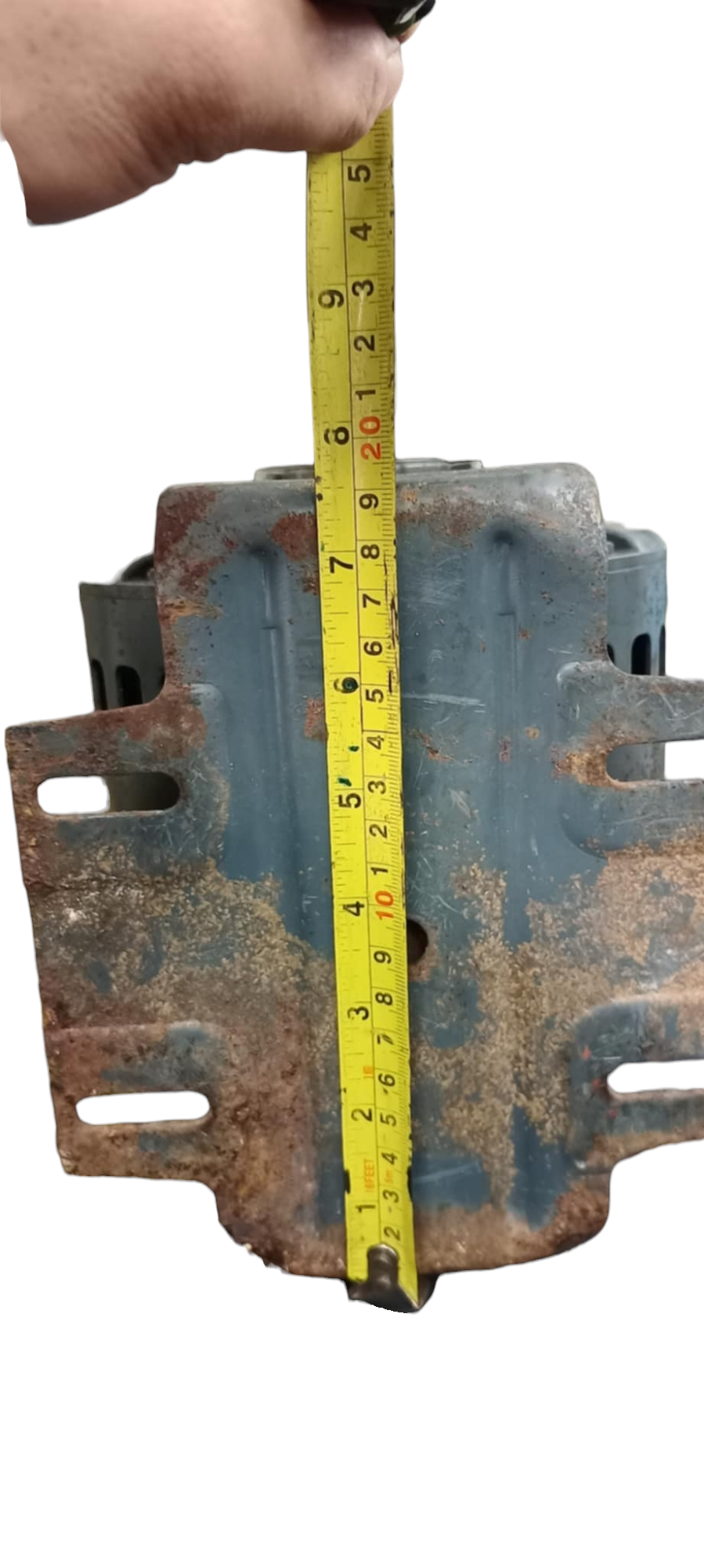 Rusty blue GE AC Motor part with tape measure showing size held by hand