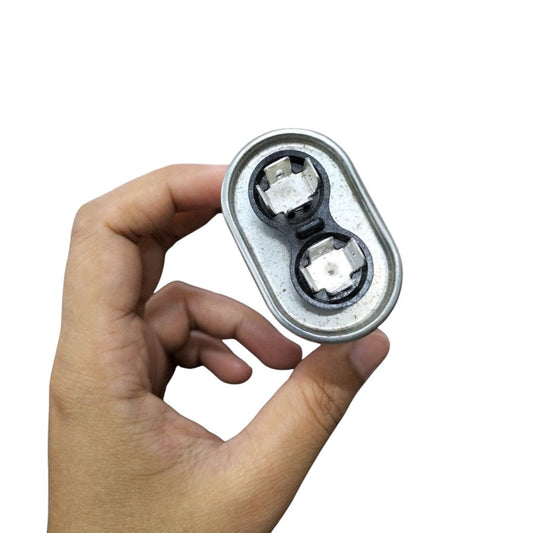 Mallory oil-filled running capacitor 440V AC held in hand, showcasing dual terminals and robust design