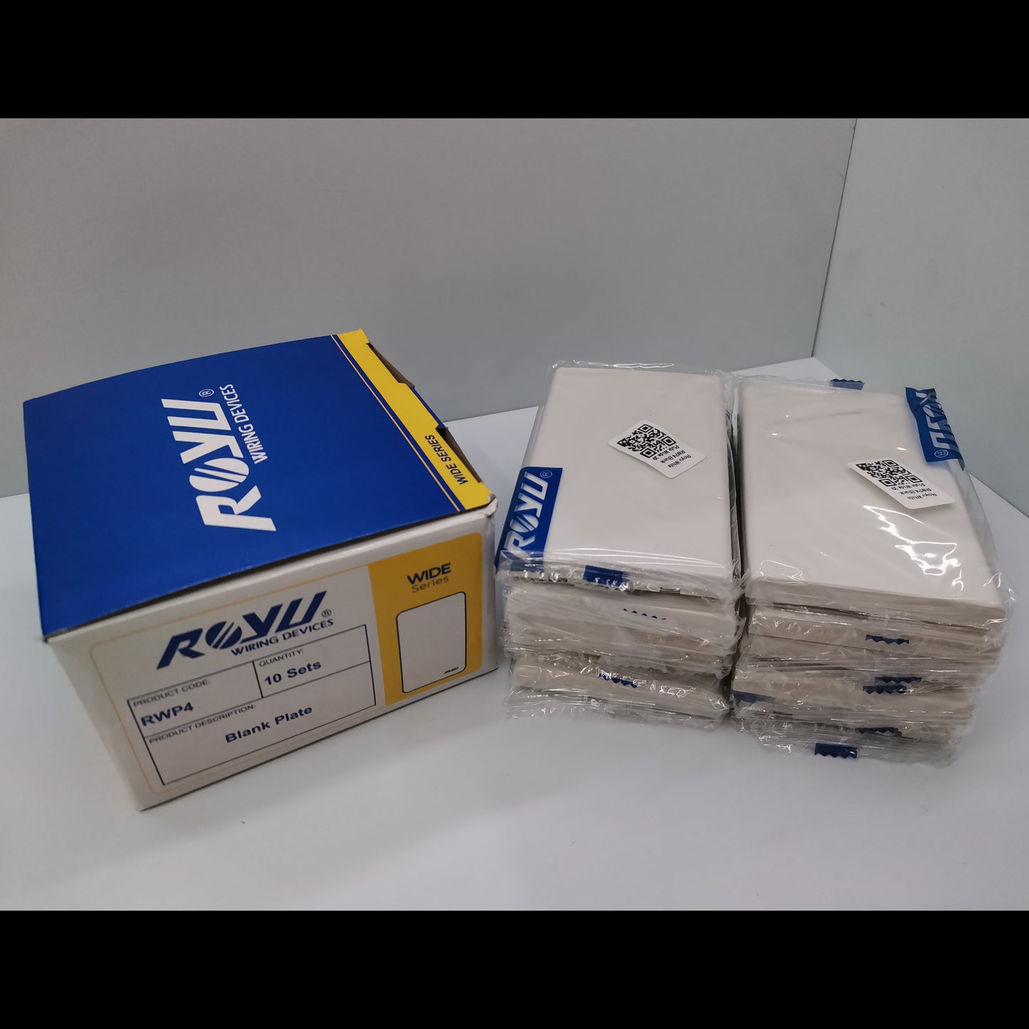 Royu Blank Faceplate Cover Plate packs showing stacked white plates and branded packaging box for power points switches and plugs