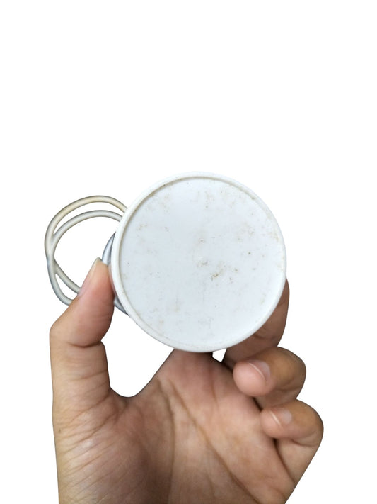 Hand holding a 70MFD 350 VAC Running Capacitor with white casing and connecting wires