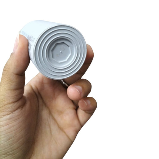 Syscap Running Capacitor 25MFD 250V shown from the top in a hand for electrical applications