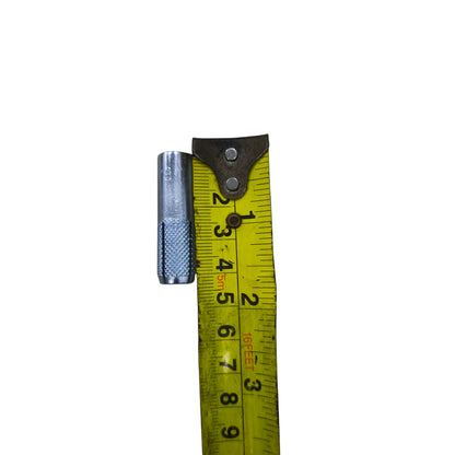 12mm x 40mm expansion bolt for concrete with knurled metal surface next to yellow measuring tape