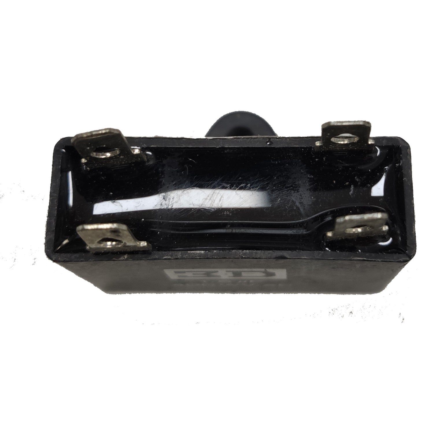 Black rectangular component with metal contacts on a white background
