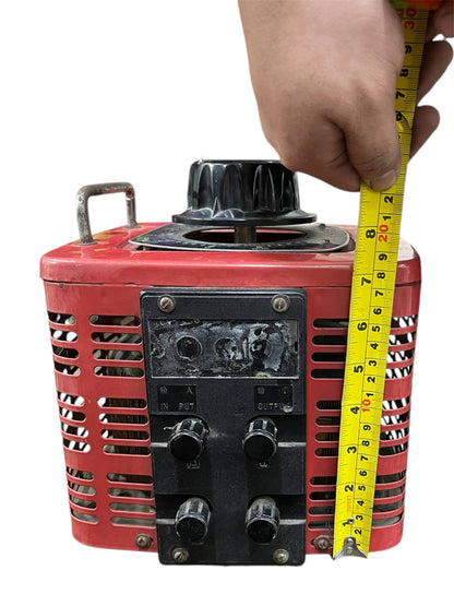 Stavol 5000W variac transformer in red with black control knobs being measured with yellow tape
