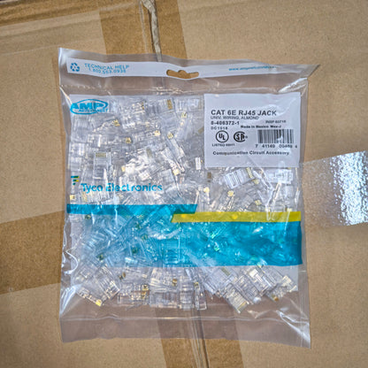 Package of AMP CAT 6E RJ45 jacks on a cardboard surface