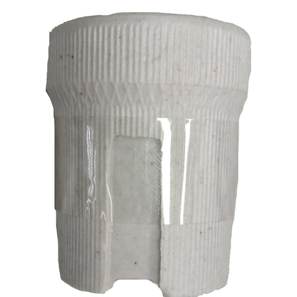 White cylindrical object with ribbed texture on a white background