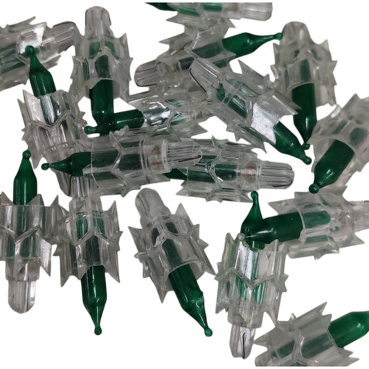 Collection of green and clear plastic components on a white background