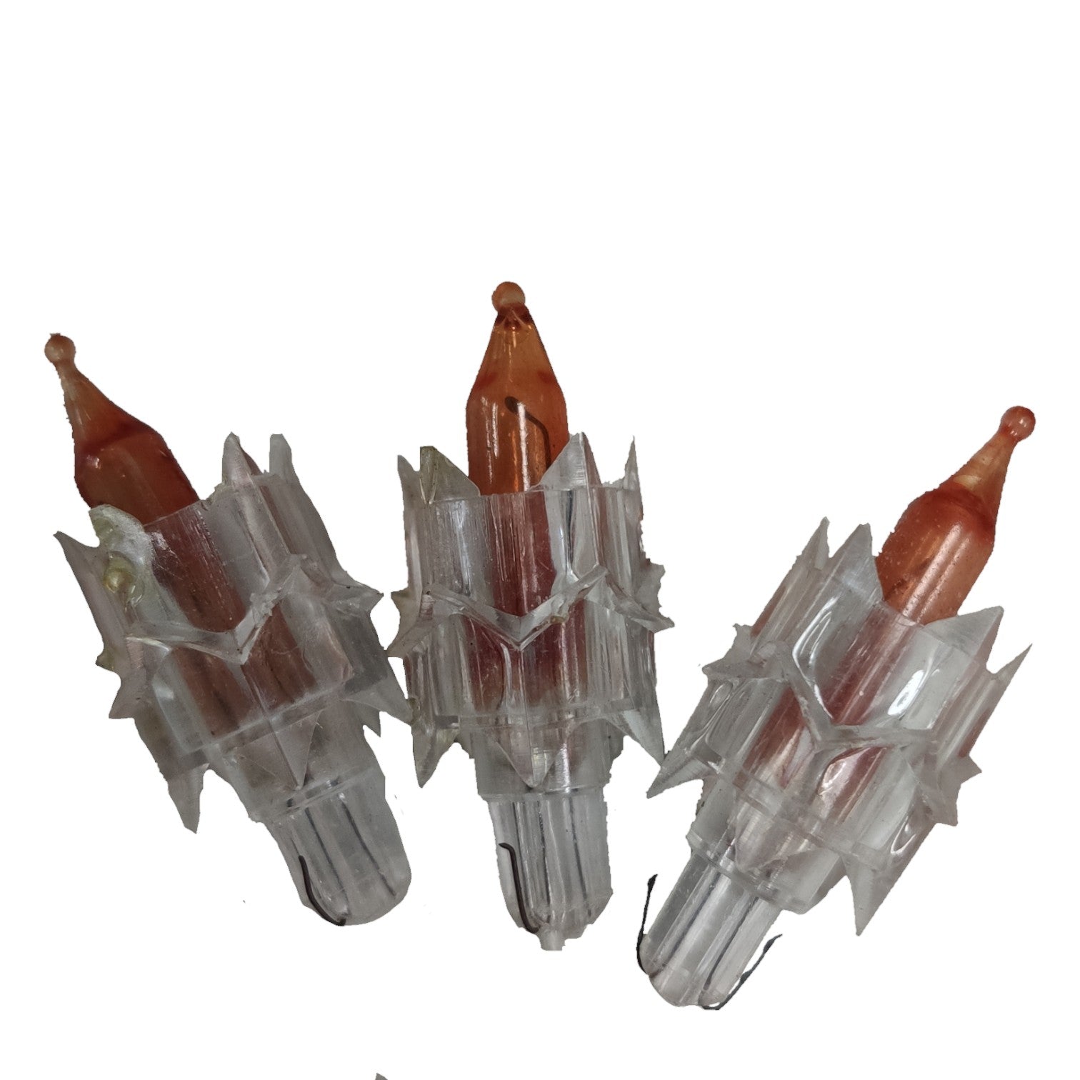 Three clear arrowheads with brown tips on a white background