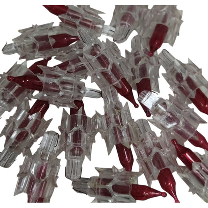Pile of red and clear plastic capsules on a white background