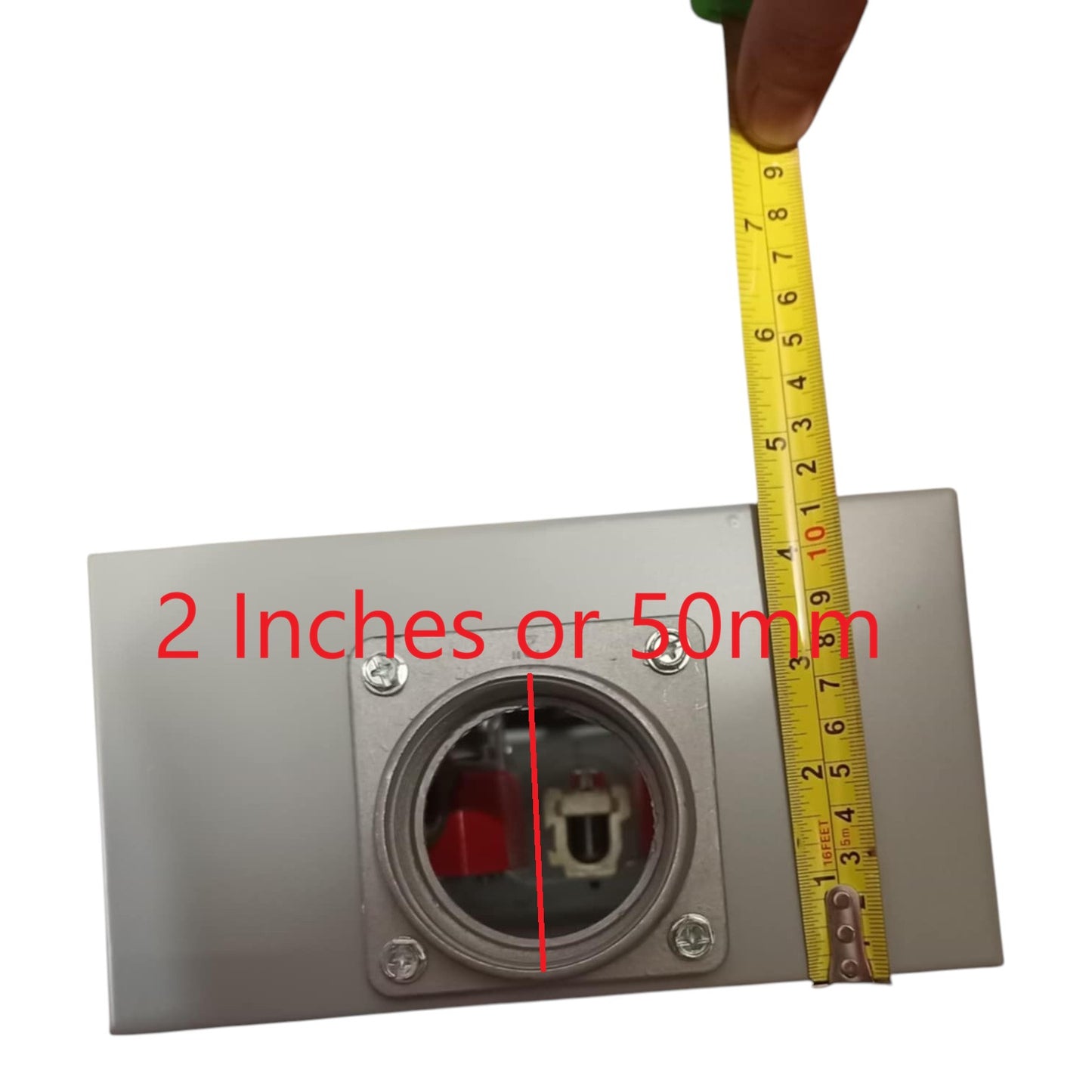 Metallic electrical outlet with a tape measure for scale on a white background