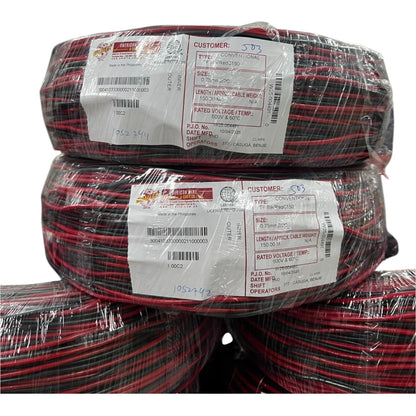 Stack of red and black cable rolls with labels on a white background