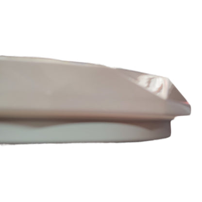 Close-up of a beige plastic object on a white background