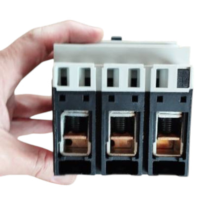 Hand holding a three-phase electrical断路器 on a white background GE 40A 3Pole 25KAIC 220V MCCB Industrial Circuit Breaker FD160 Electx Electrical Supply