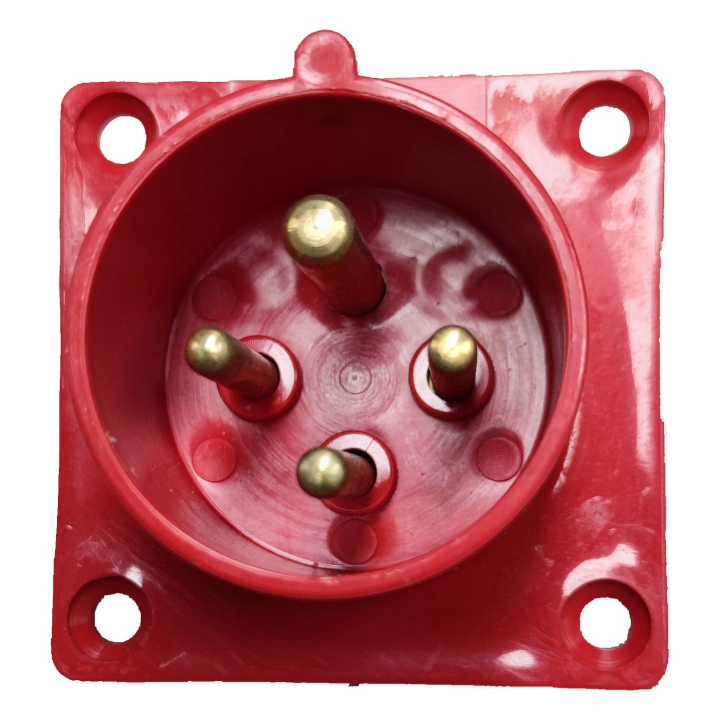 Red electrical socket with brass pins on a white background