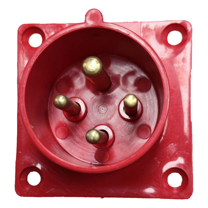 Red electrical socket with brass pins on a white background