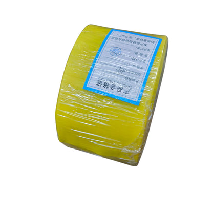 Yellow roll of plastic wrap with a label on a white background