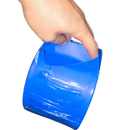 Hand holding a blue plastic scoop against a white background