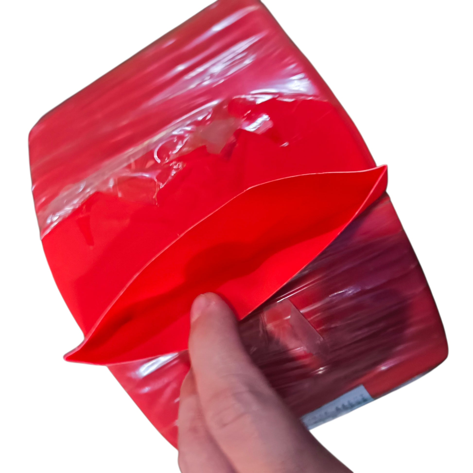 Red plastic bag with a hand holding it on a white background