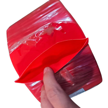 Red plastic bag with a hand holding it on a white background