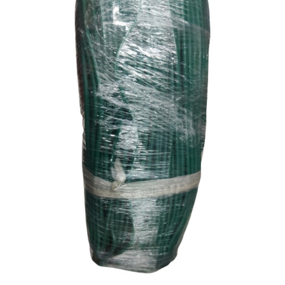 Green cylindrical object wrapped in clear plastic on a white background
