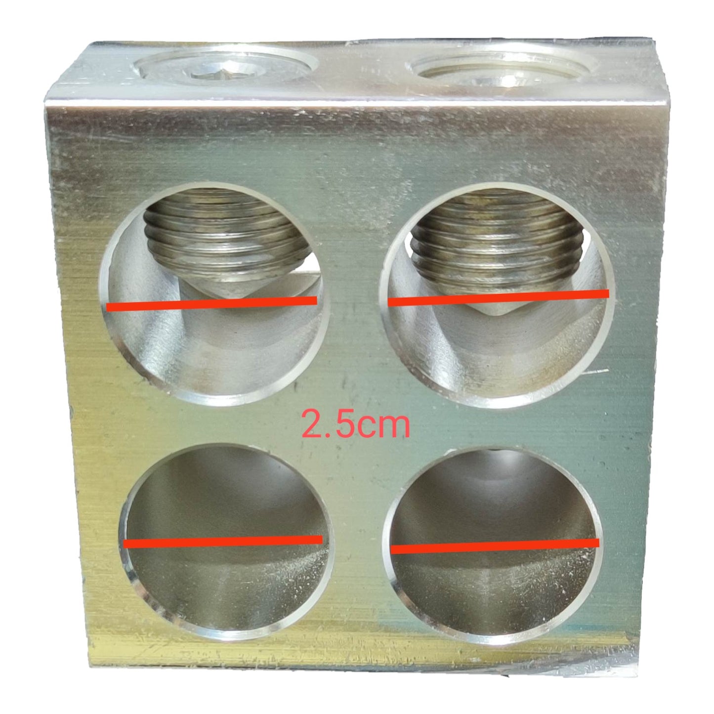 Metallic block with circular holes and measurement markings on a white background