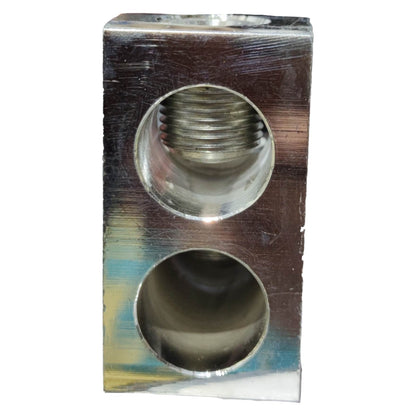 Metal fitting with threaded and smooth cylindrical holes on a white background
