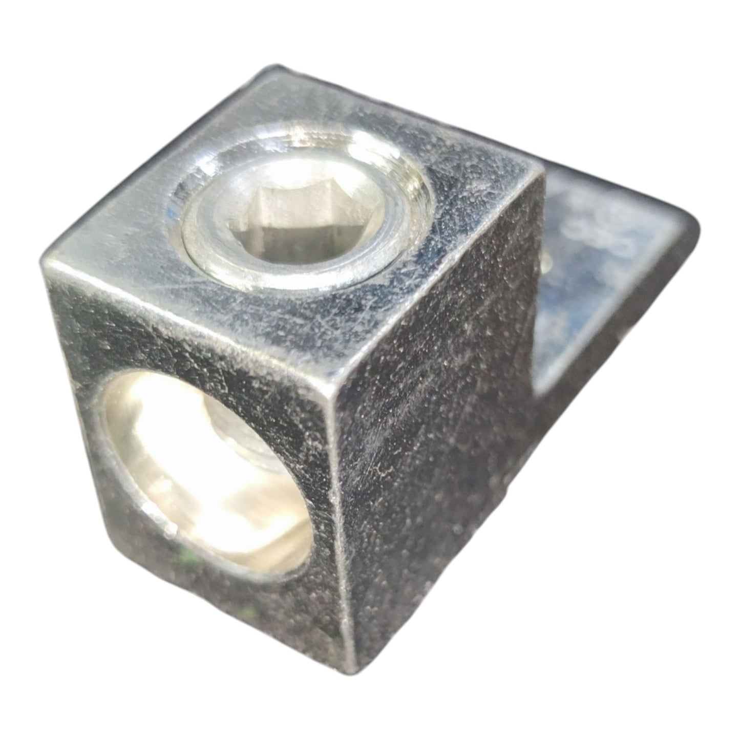 Metal block with two circular holes on a white background
