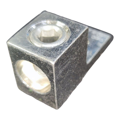 Metal block with two circular holes on a white background