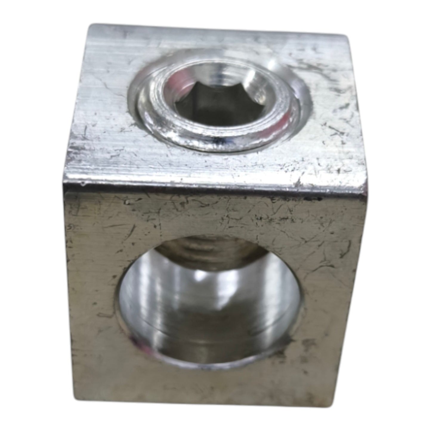 Metal block with cylindrical holes on a white background