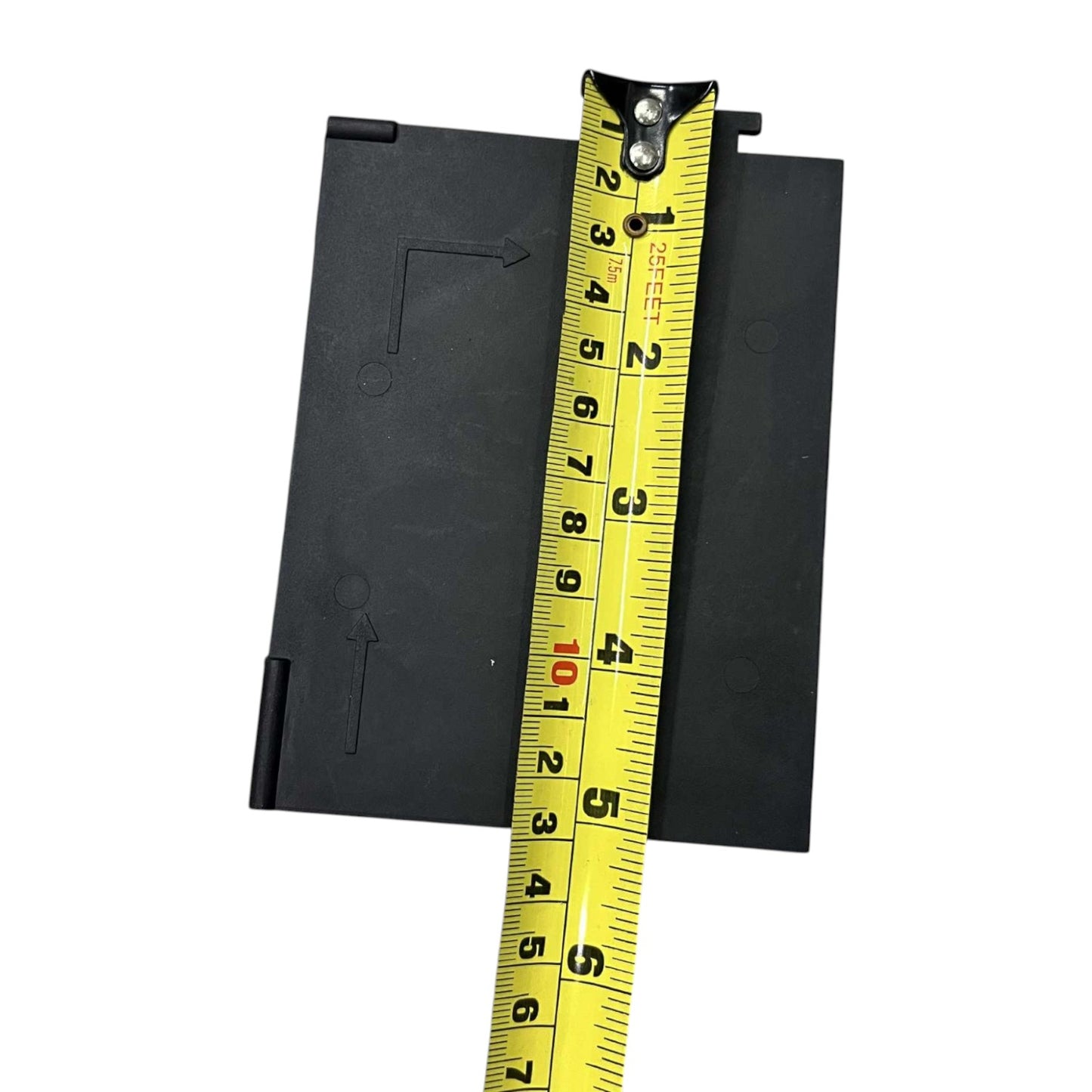Black rectangular object with a yellow measuring tape on a white background