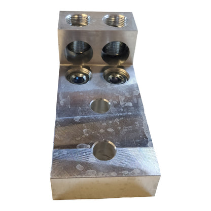 Metal block with threaded holes on a white background