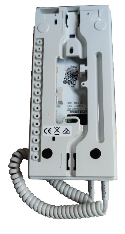 Back view of Aiphone 6 station intercom showing wiring terminals and coiled white cord