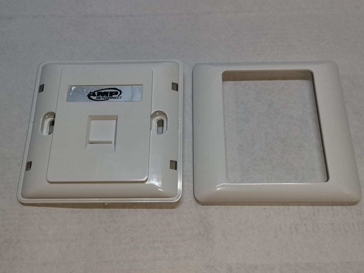 AMP 1 gang faceplate in white plastic with two parts for power points and switches