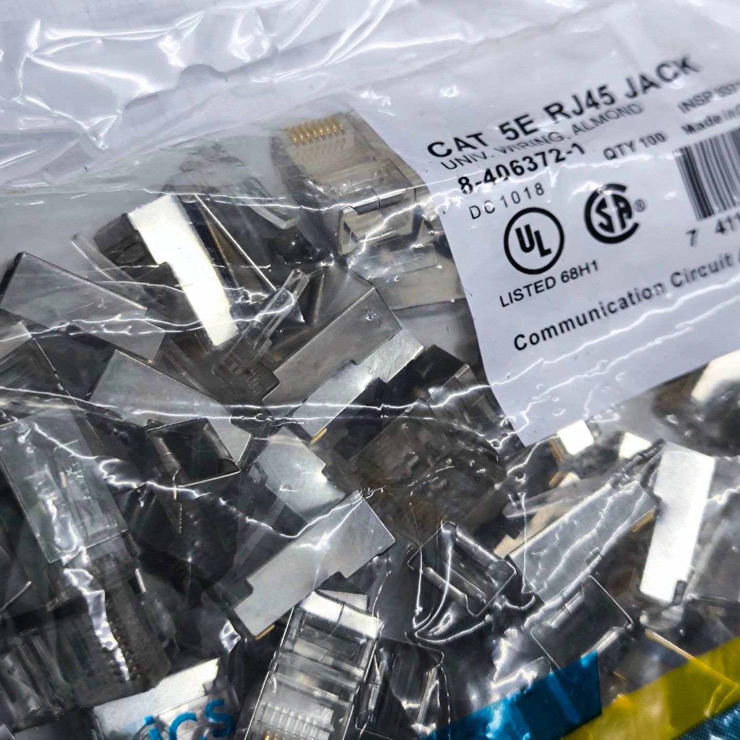 Bulk package of AMP CAT 5e shielded RJ45 connector parts for communication circuitry projects