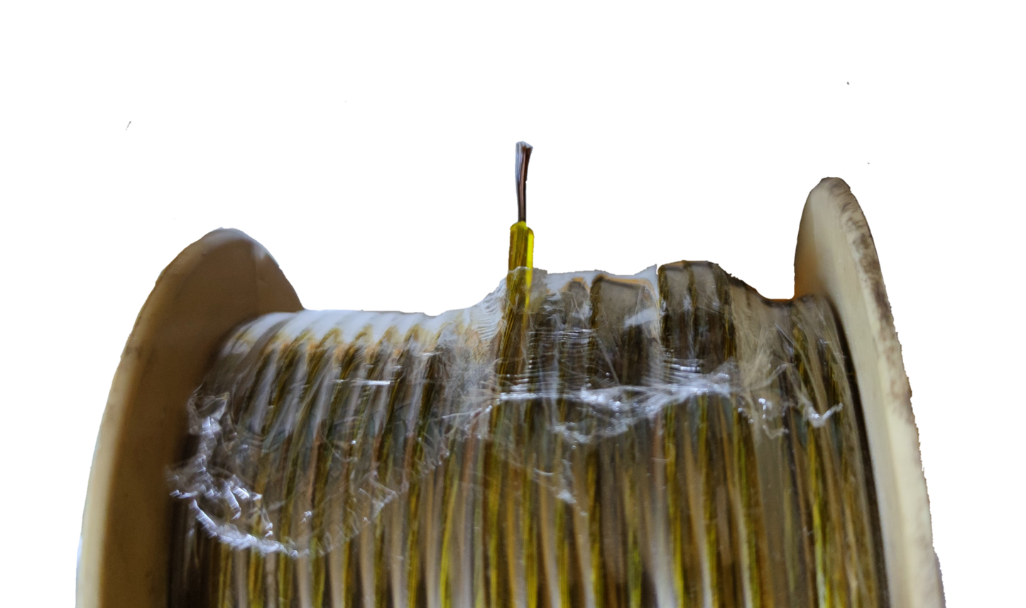 Win clear insulated automotive wire roll on beige spool with exposed conductor and protective plastic wrap