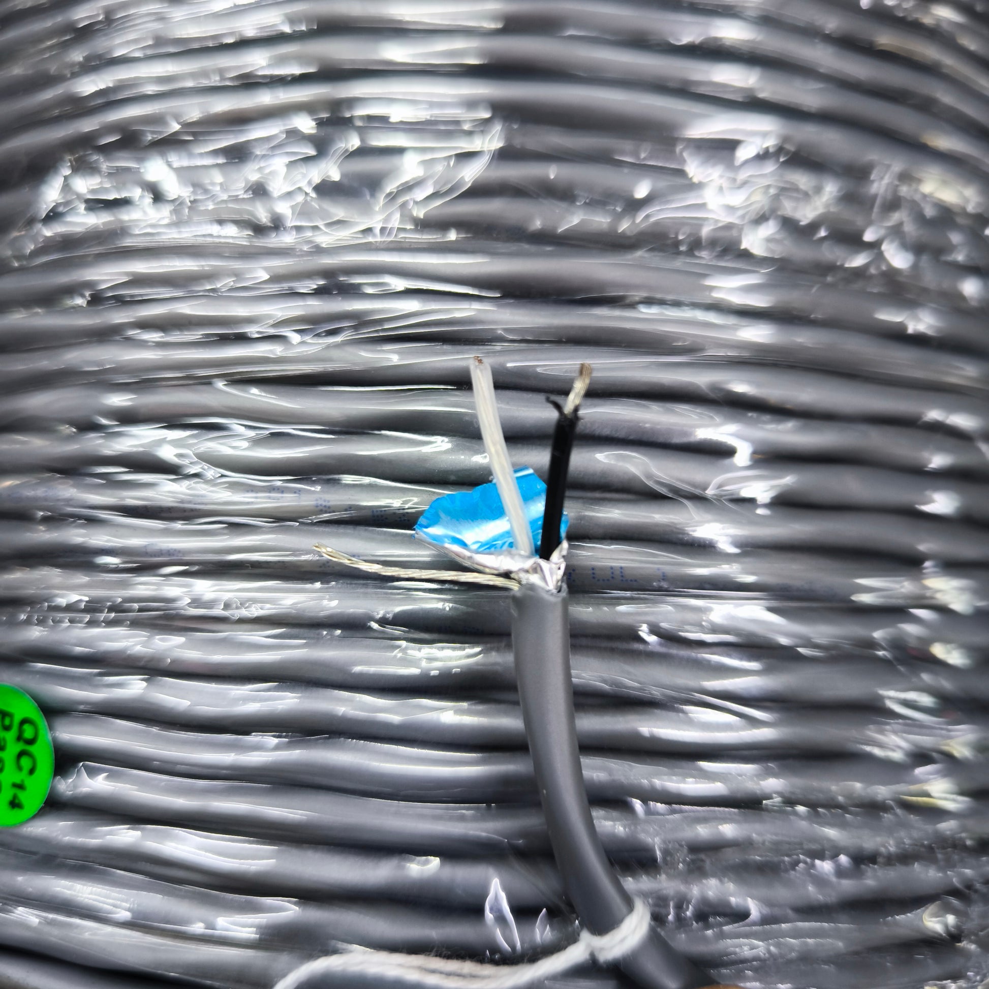 Belden 22AWG shielded cable with black and white wires and foil shielding on spool