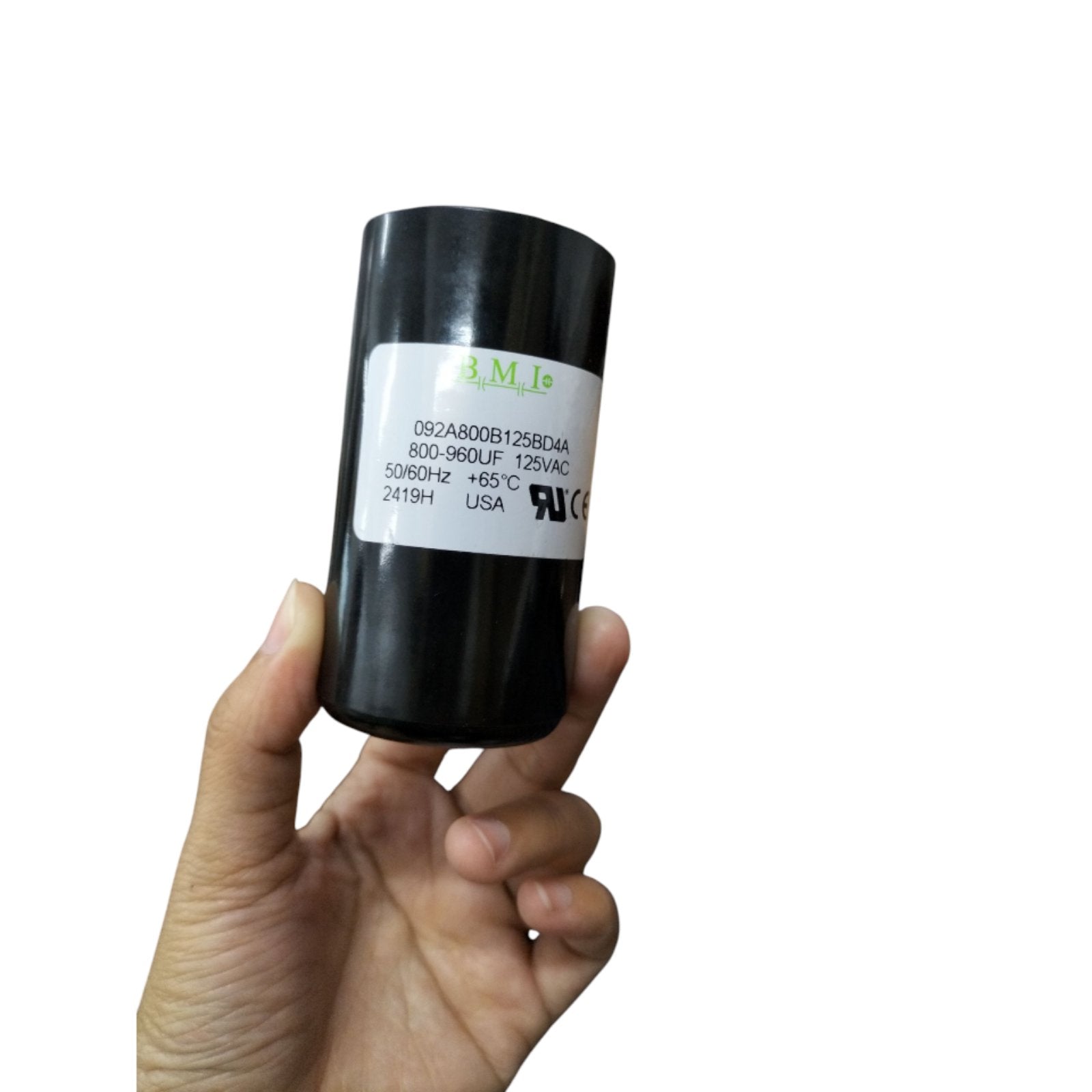 BMI motor starting capacitor 800-960uF 125V in a cylindrical black casing held in a hand