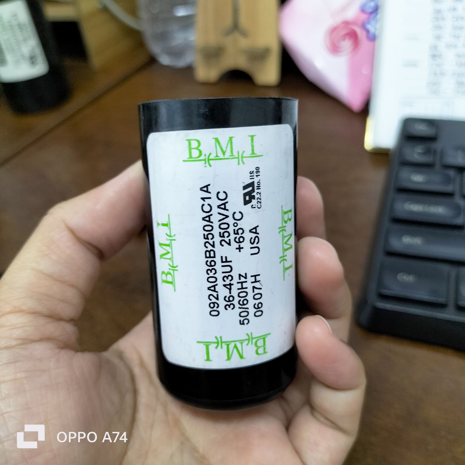 BMI Starting Capacitor 36-43 UF held in hand showing specifications and rating details