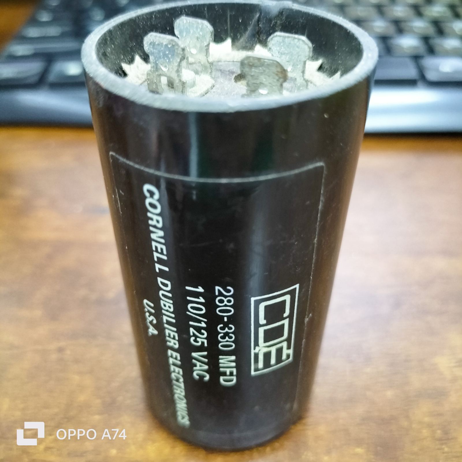 Brand CDE 280-330 MFD 110-125V black electrical capacitor with metal terminals for circuitry