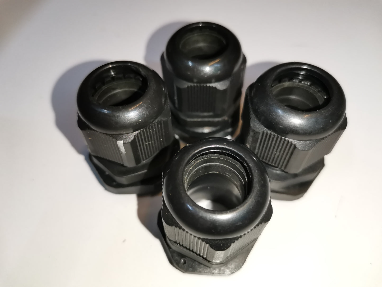 Grippes black Cable Gland M25 13-18mm for cable management, showing four units on white background