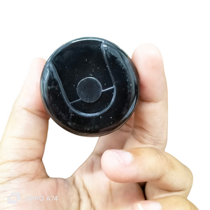 CDE 110-125V motor start capacitor held in hand for easy reference and size comparison