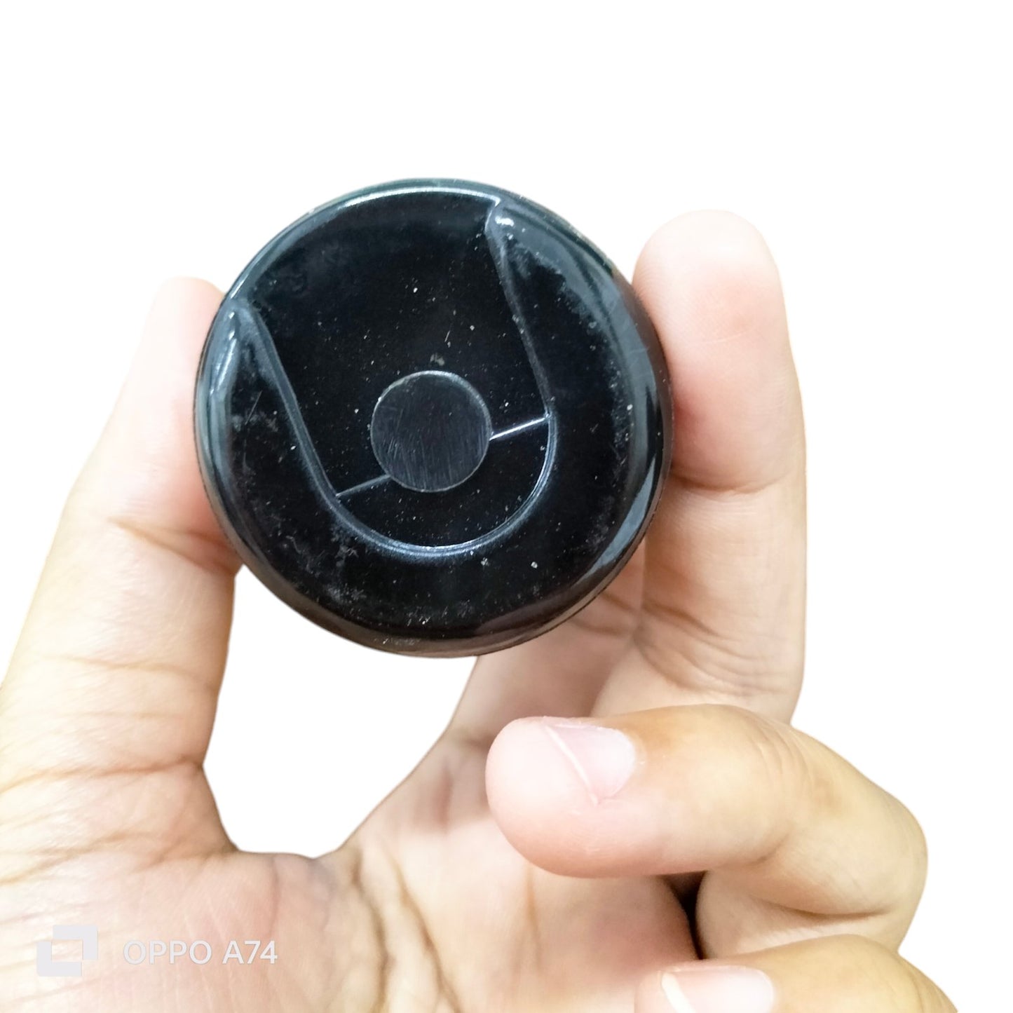 Starting Capacitor CDE Brand 324-388 MFD held between fingers, black electrical circuitry part