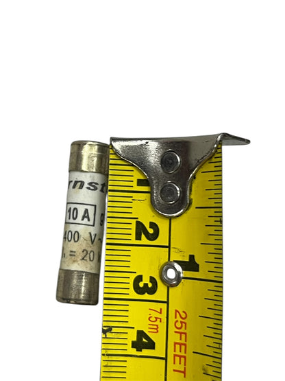 Ceramic Fuse 10A 400V 8x31mm next to a yellow measuring tape showing its size
