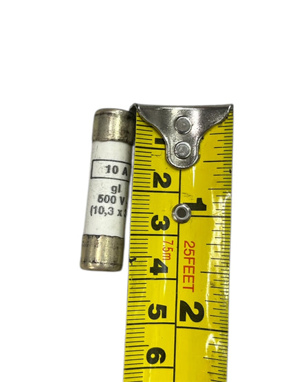 Ceramic Fuse 10A 500V 10x38mm next to yellow measuring tape showing size
