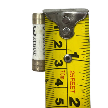 Ceramic Fuse 12A 400V 8x31mm next to yellow measuring tape showing size