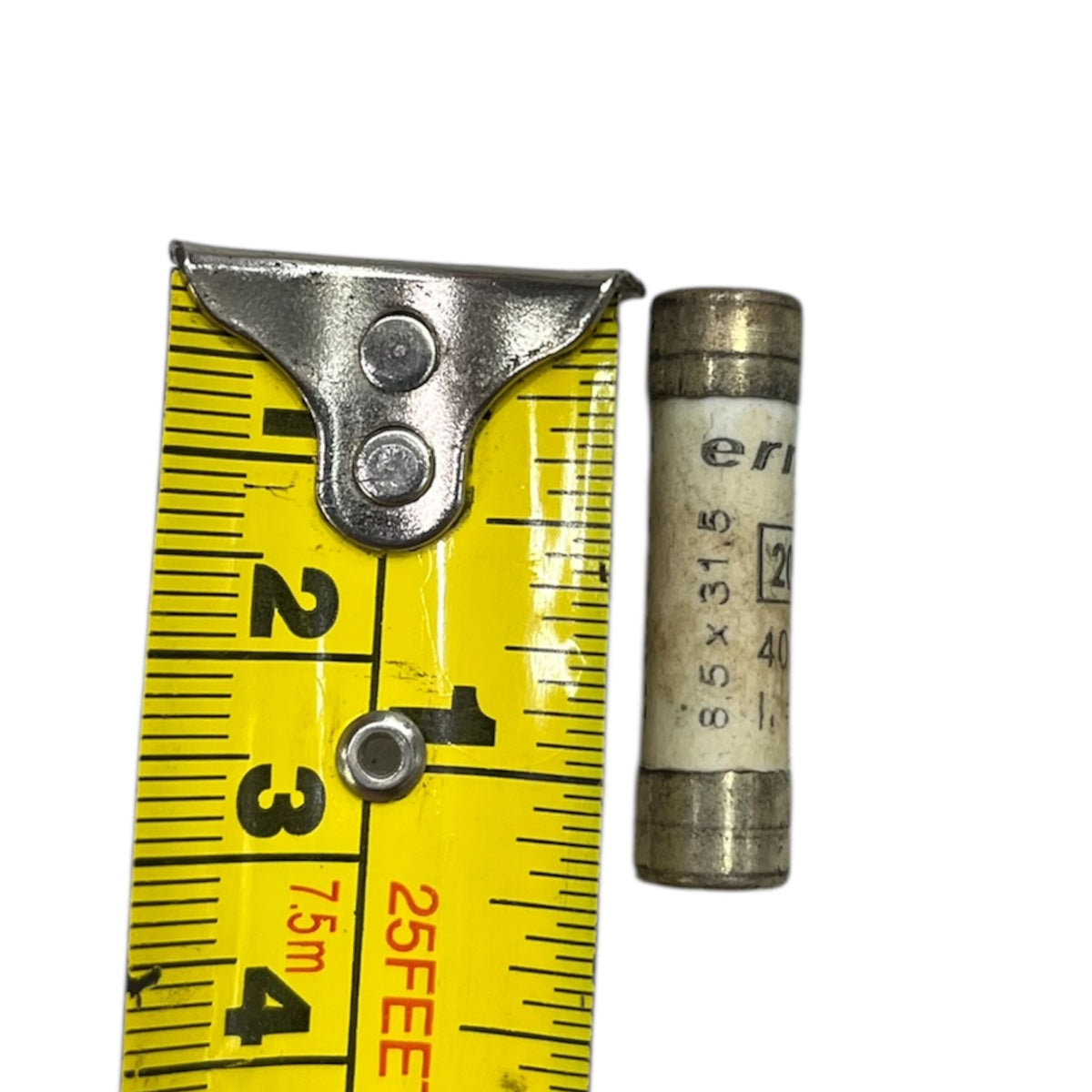 Ceramic Fuse 20A 400v 8x31mm electrical component next to yellow measuring tape