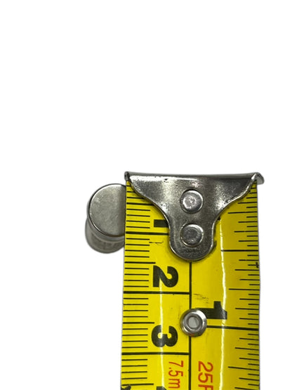 Close-up of ceramic fuse 32A 500V 10x38mm next to yellow measuring tape showing size