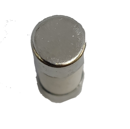 Close-up of a China made Ceramic Fuse 8A 10x38mm electrical component on black background