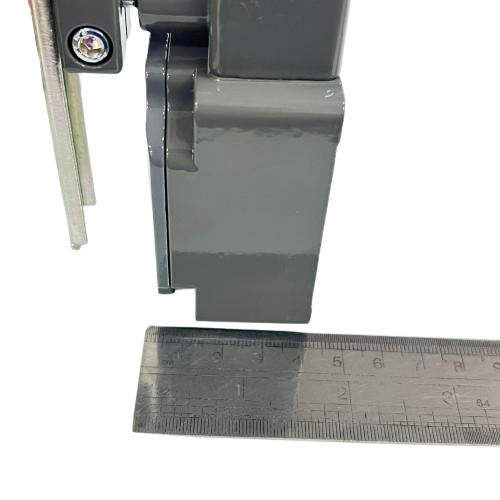 Close-up of Chint limit switch 5A 220V showing metal body and measurement ruler for scale